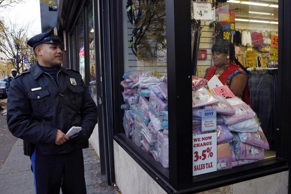 Camden Police Officer L.A. Sanchez walks a beat in a downtown shopping area in Camden, N.J. Camden's city council last night voted to slash the police force in half and the fire department by one-third, as it struggles to meet a $26 million shortfall. (AP)