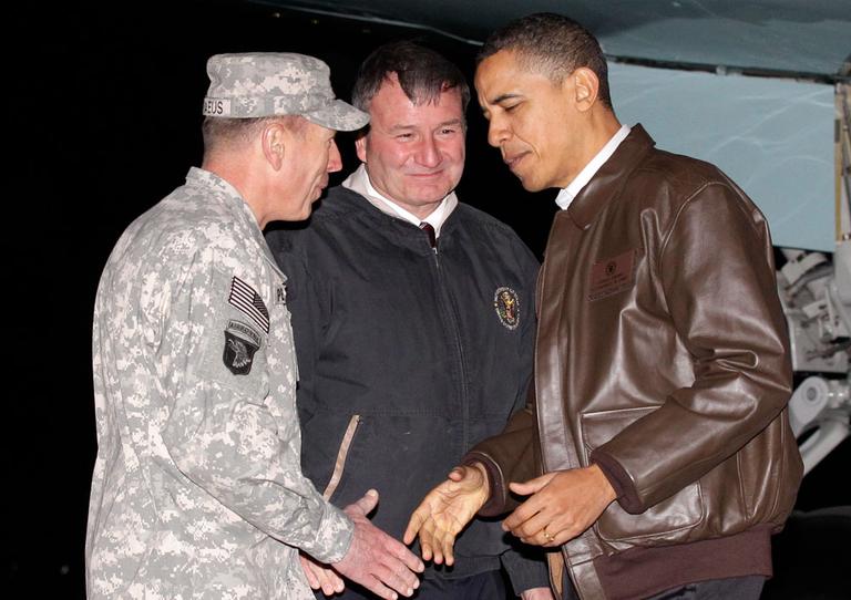 President Obama is greeted by Gen. David Petraeus, left, and U.S. Ambassador to Afghanistan Karl Elkenberry, center, at Bagram Air Base in Afghanistan on Friday. (AP)