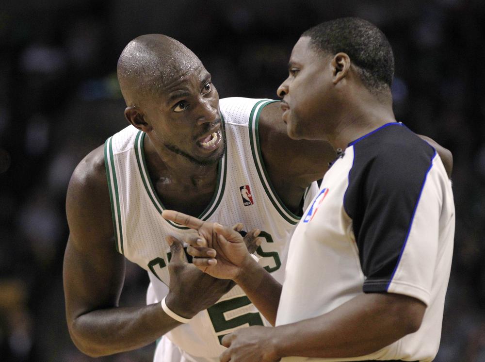 Kevin Garnett, left, argues a call against him with referee Leroy Richardson during the second quarter, Friday. (AP Photo/Charles Krupa)