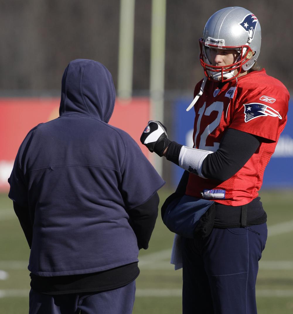Bill Belichick talks with Tom Brady before practice at the team&#39;s facility in Foxborough on Thursday. (AP)