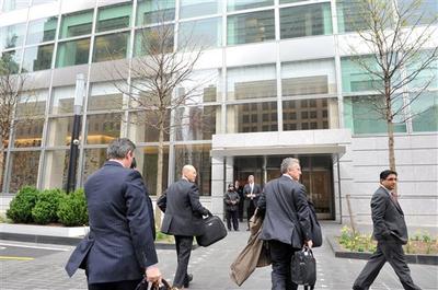 People enter the Goldman Sachs headquarters in New York. According to the New York Times, Goldman plans bonuses early and sets the standard for other banks. (AP)