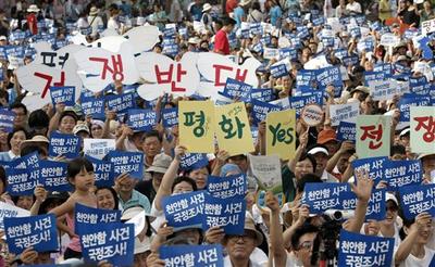 South Koreans hold pro-unification signs during a rally on Korea's Liberation Day in Seoul, South Korea. (AP)