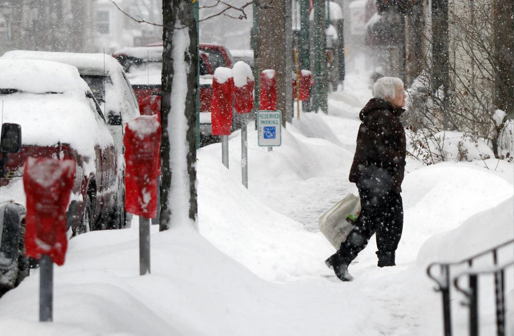 Snow storms are pounding Randolph, Ny., and other towns in the Great Lakes region.  In Meadville, Pa., a woman makes her across a snow covered sidewalk after storms dumped more than two feet of snow there. (AP)