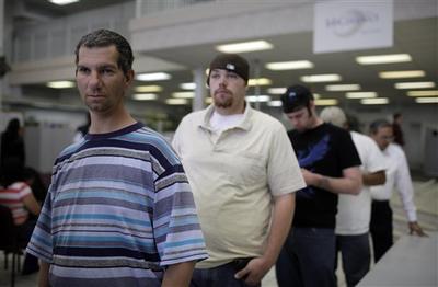 Joseph Sassi, 39, left, waits in line to talk to a job counselor at a Nevada Jobconnect Career Center in Las Vegas. (AP)