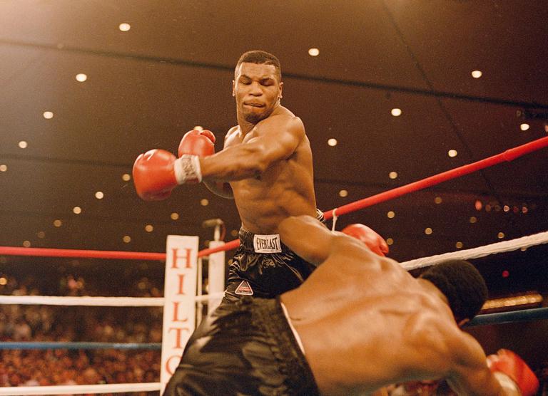 Mike Tyson knocks down Trevor Berbick on Nov. 22, 1986. It took Tyson two rounds to become, at age 20, the youngest heavyweight champion ever. (AP)