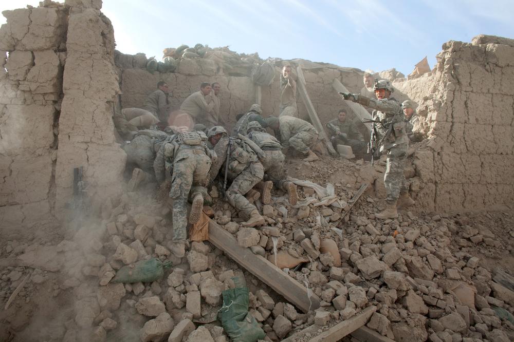 Soldiers dug through the rubble after a bomb destroyed an outpost in Kandahar Province. Six Americans were killed. (Tyler Hicks/The New York Times)        