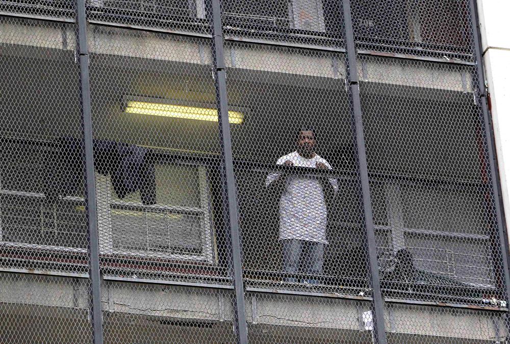 A resident watches as movers, hired by the Chicago Housing Authority, remove another resident&#039;s belongings from the last high-rise of Chicago&#039;s Cabrini Green public housing project. (AP)