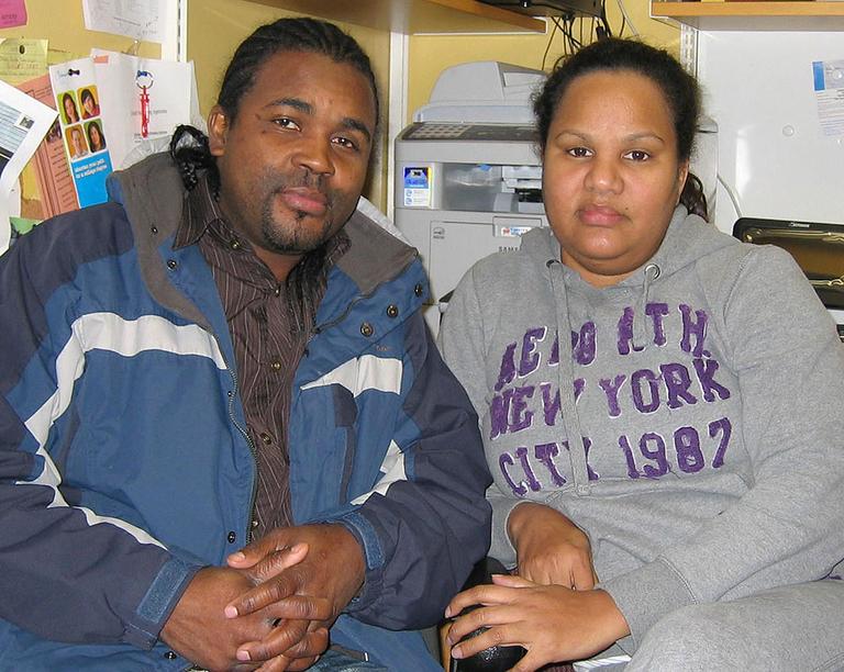 After their Hyde Park home was taken, Pierre Solon and Katty Famila now live in an apartment in Mattapan. (Anthony Brooks for WBUR)