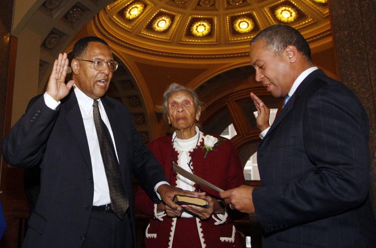 Gov. Deval Patrick, right, swears in new Chief Justice Roderick Ireland as Ireland's mother, Helen Ireland, holds the Bible on Monday in Boston. (AP)