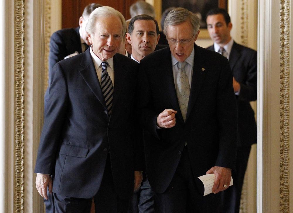 Sen. Joe Lieberman, I-Conn., left, and Senate Majority Leader Sen. Harry Reid, D-Nev., right, with Joe Solmonese, president of the Human Rights Campaign, center, head to a news conference about the military's &quot;Don't Ask Don't Tell&quot; policy. (AP)