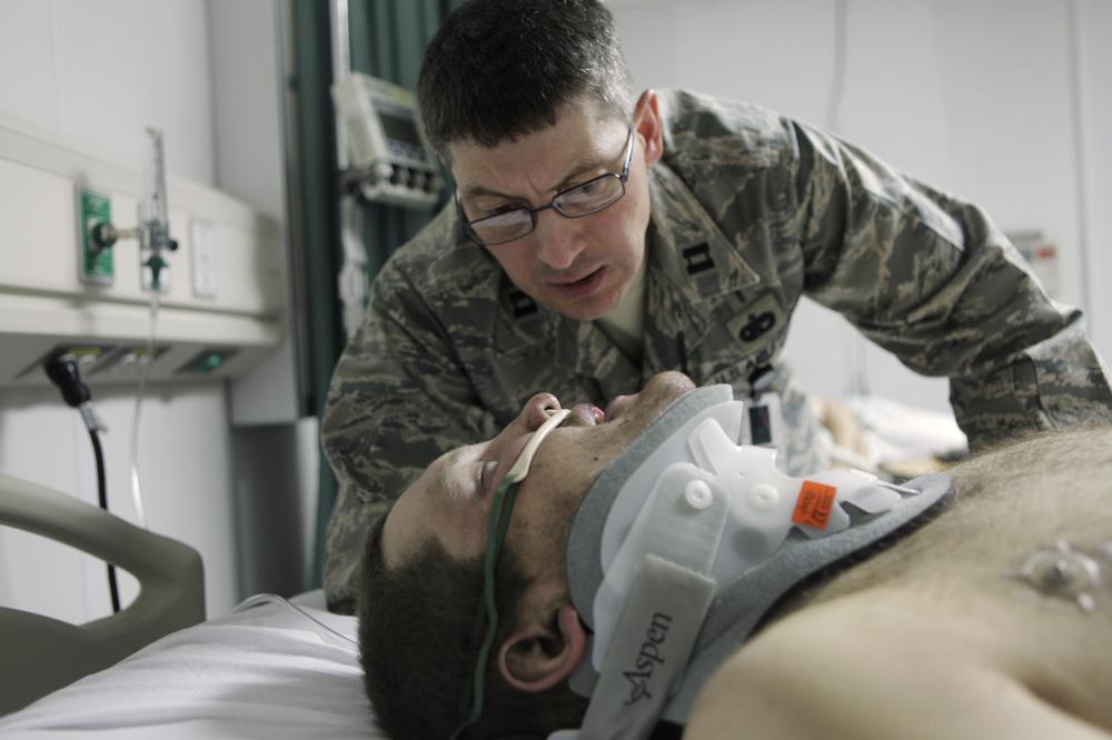 Kentucky Air National Guard Chaplain Capt. Kerry Wentworth, comforts U.S. Pfc. Anthony Vandegrift, of Mililani, Hawai, with Bravo Company 287, 3rd Brigade, 10th Mountain Division, at the emergency room of the U.S. hospital in Bagram Air base, north of Kabul, Afghanistan, after he was wounded at a roadside bomb. (AP)
