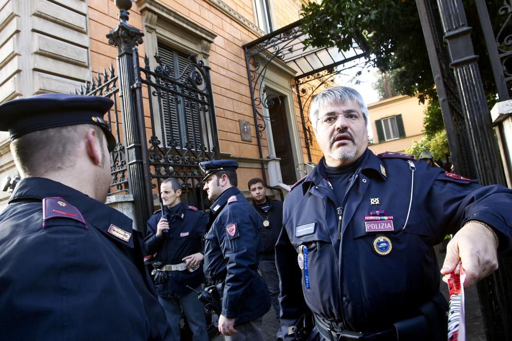 Police officers stand outside the Chilean embassy, in Rome, after a pair of package bombs exploded at the Swiss and Chilean embassies in the city. (AP)