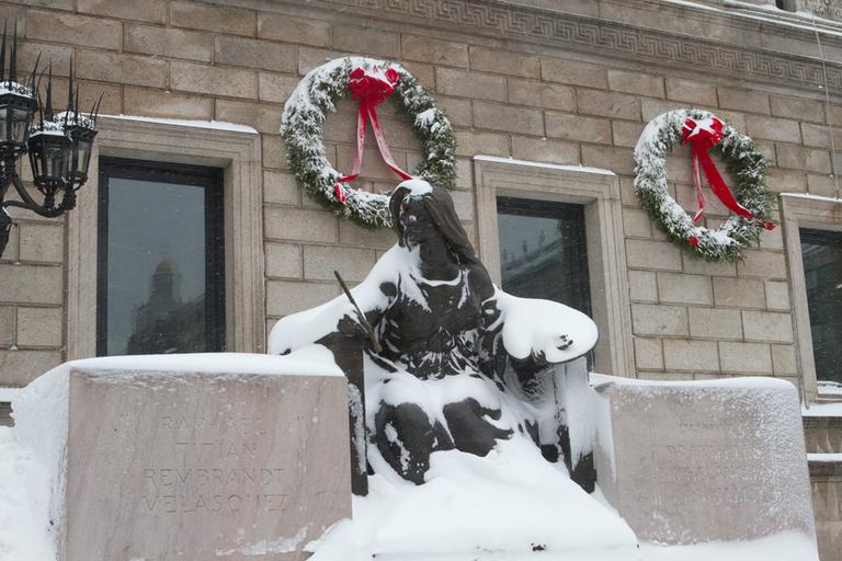 A statue outside the Boston Public Library was covered in snow. (Nick Dynan for WBUR)