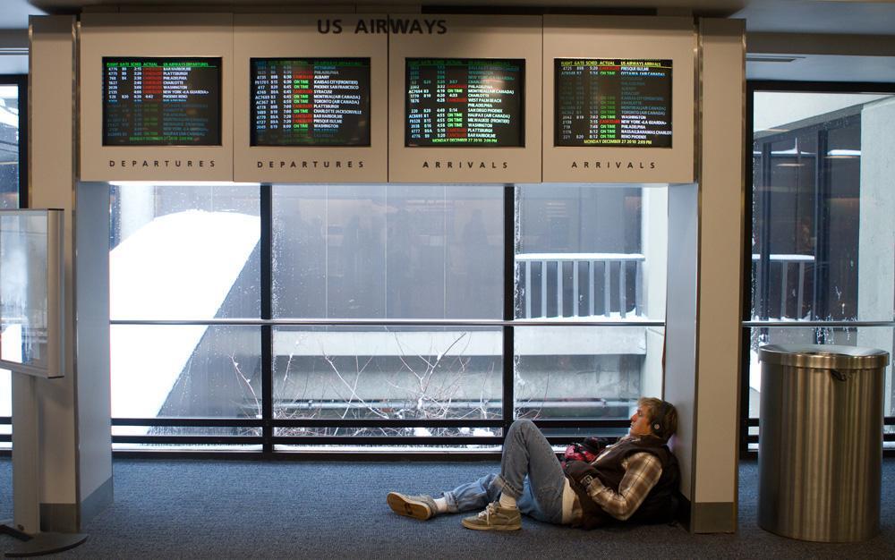 A passenger at Boston's Logan Airport, waiting for his plane. (Nick Dynan for WBUR)