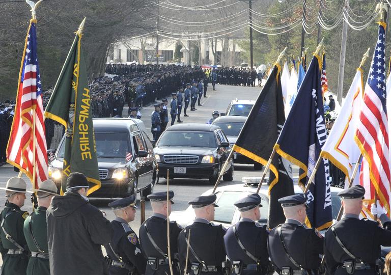 Police stood guard at the memorial service for Woburn Police Officer Jack Maquire in Wilmington, Friday. (AP)