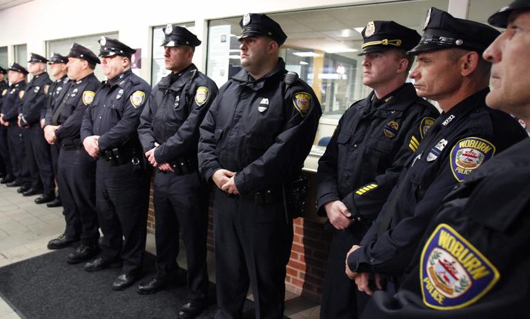 Woburn police officers line up before the news conference announcing an officer's death in Woburn Monday. (AP)