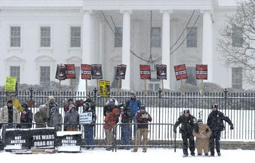 A protestor is carried away by police during a demonstration outside the White House in Washington, Thursday, Dec. 16, 2010. (AP Photo/Susan Walsh)