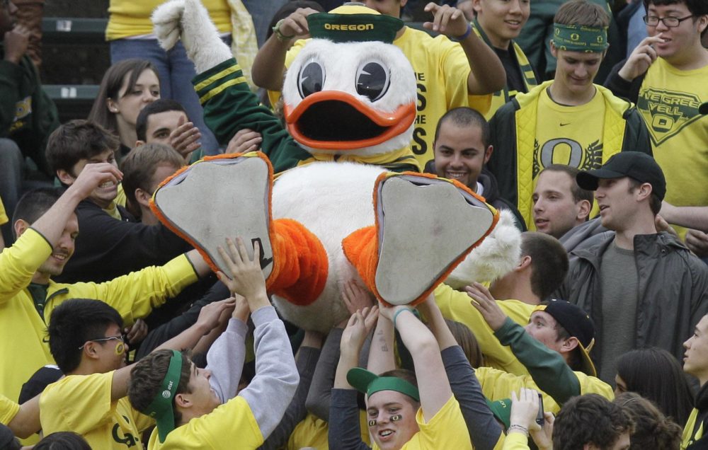 The Oregon Duck is passed over the heads of Oregon fans. (AP)
