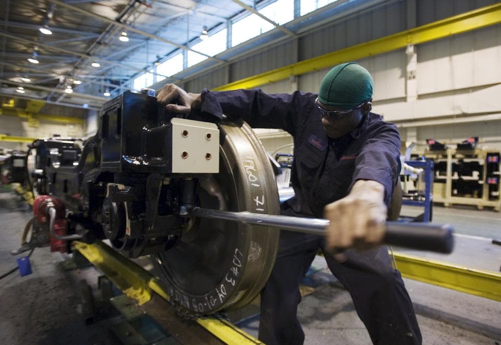 Walter Lino uses a wrench on a wheel assembly of a New York City subway car at the Kawasaki manufacturing facility in Yonkers, N.Y. (AP)