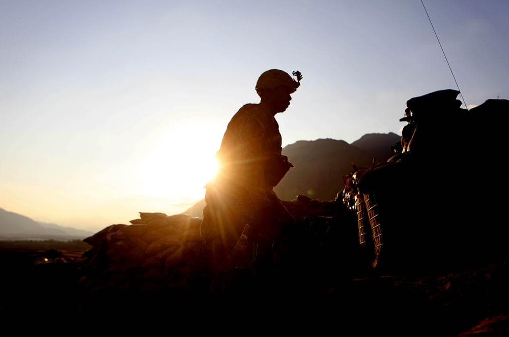 Pfc. Robinson Chaz of the 2nd Platoon Bravo Company 2-327 Infantry walks at sunset at Badel Combat Out Post in Kunar province in eastern Afghanistan near the Pakistan border. (AP)