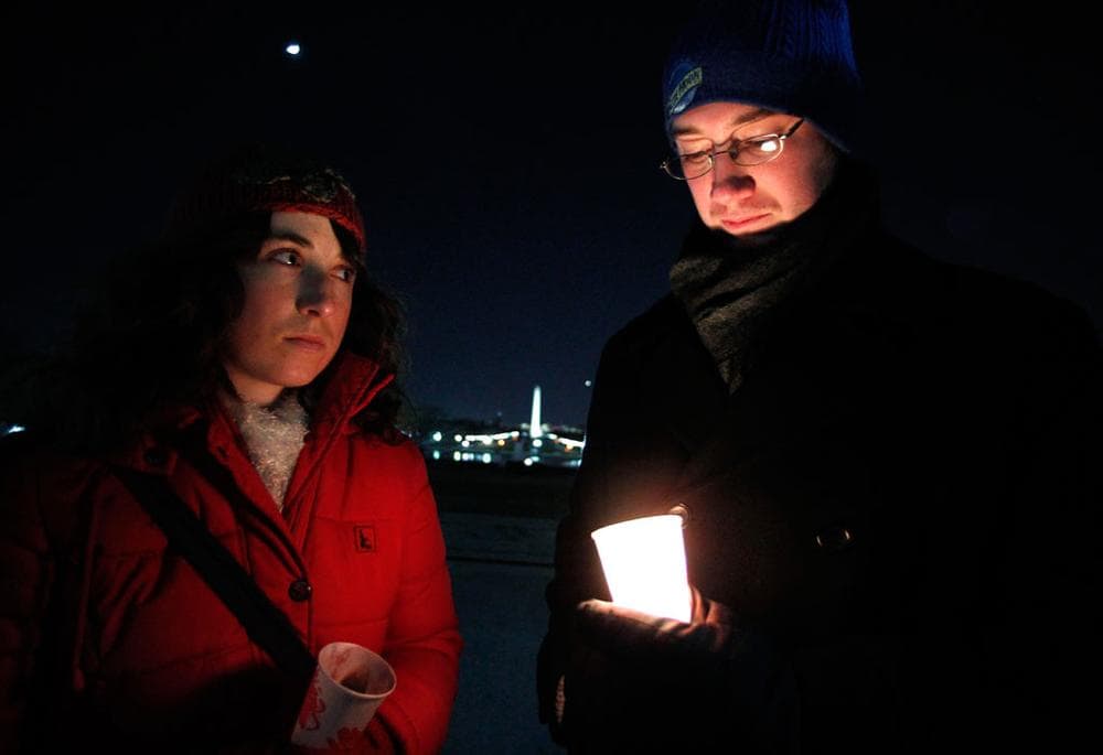 Sarah Wendel, left, and Brett Wolf join a vigil on Sunday at the U.S. Capitol in support of Rep. Gabrielle Giffords, D-Ariz., and the victims of Saturday's shooting in Tucson. (Manuel Balce Ceneta/AP)