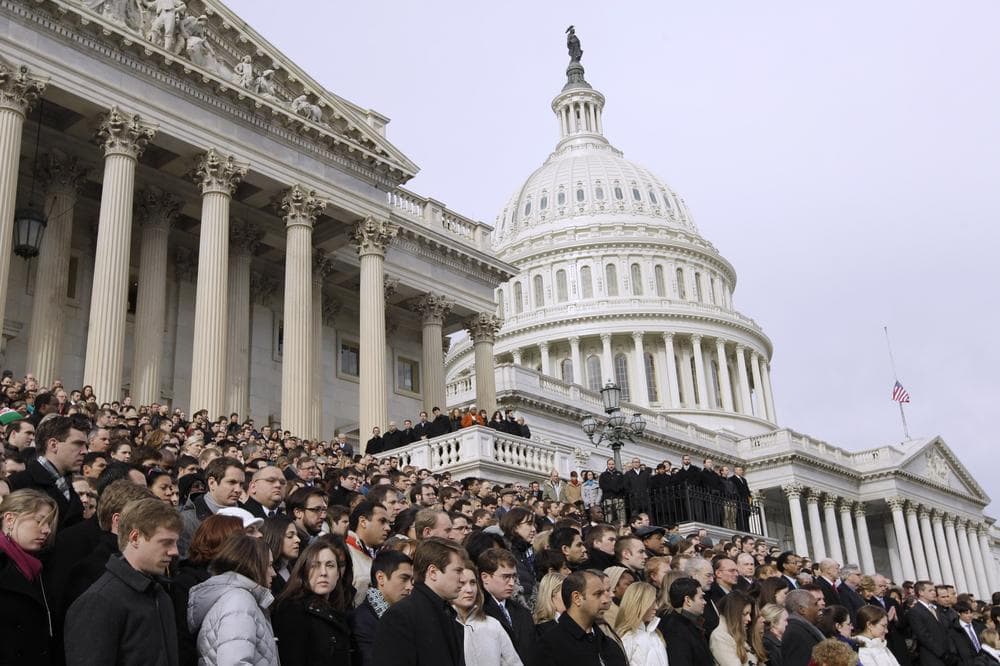 Members of Congress and staff members observe a moment of silence for Rep. Gabrielle Giffords, D-Ariz., and other shooting victims, Monday, Jan. 10, 2011, on the East Steps of the Capitol on Capitol Hill in Washington. (AP)
