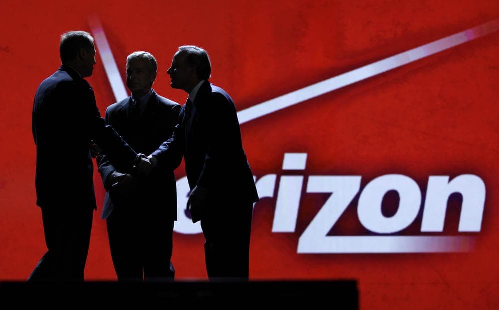 Consumer Electronics Association president Gary Shapiro, left, greets Verizon Communications Inc., chairman Ivan Seidenberg, right, and president Lowell McAdam during the Consumer Electronics Show, in Las Vegas.  (AP)