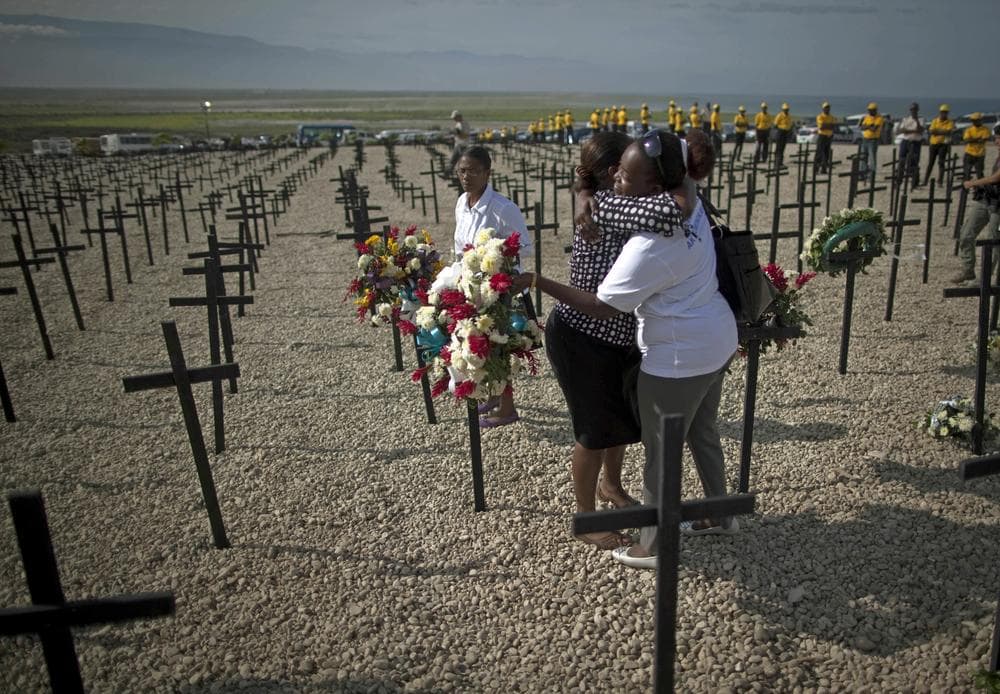 Two women embrace during a religious ceremony held at the Titanyen mass grave site on the outskirts of Port-au-Prince, Haiti. (AP)