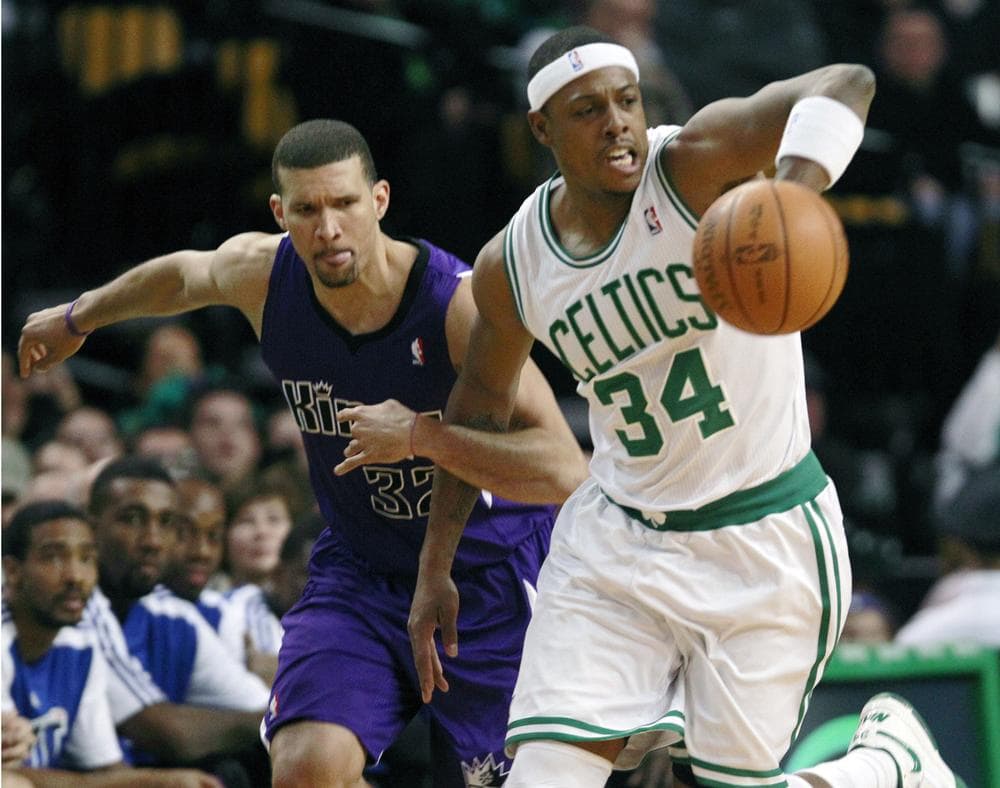 Boston forward Paul Pierce, right, passes the ball up court as Sacramento forward Francisco Garcia grabs his arm during the first quarter of the game in Boston on Wednesday. Pierce had 25 points in the Celtics 119-95 win. (AP)