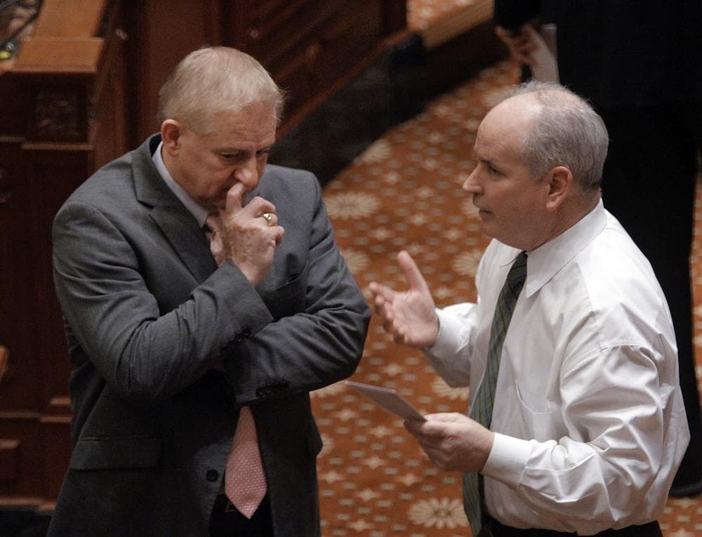 Reps. Dan Brady, right, R-Bloomington, and Roger Eddy, R-Hutsonville confer on the House floor during a session at the state Capitol in Springfield, Ill. (AP)