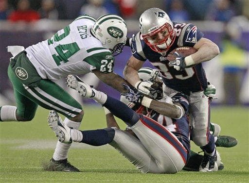 New York Jets cornerback Darrelle Revis (24) tackles the Patriots' Wes Welker (83) during the teams' NFL divisional playoff game in Foxborough, Mass. (AP)