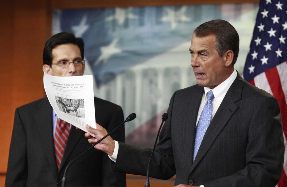 House Speaker John Boehner of Ohio, right, accompanied by House Majority Leader Eric Cantor of Va., holds a copy of a proposal to repeal the Health Care Bill during w news conference on Capitol Hill on Jan. 6, 2011. (AP)