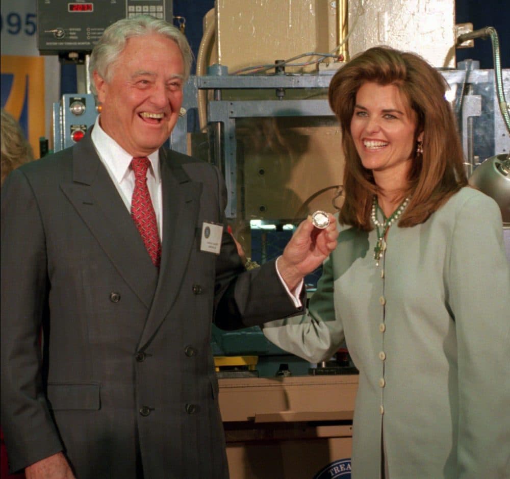 R. Sargent Shriver and his daughter, Maria, hold a newly minted commemorative silver dollar coin honoring his wife, Eunice Kennedy Shriver, at the U.S. Mint in Philadelphia, in 1995. (AP) 