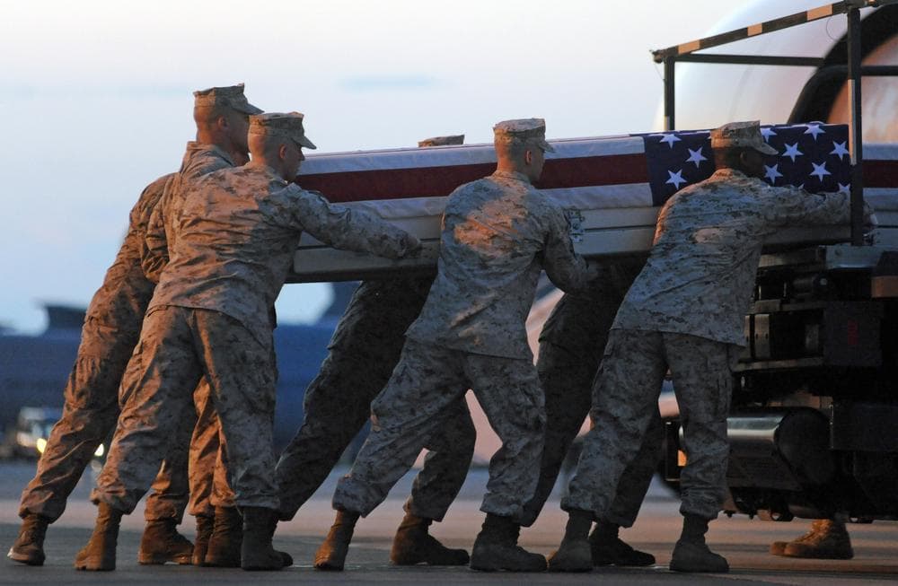 A Marine carry team lifts a transfer case containing the remains of Cpl. Paul J. Miller at Dover Air Force Base, Del. According to the Department of Defense, Miller, of Traverse City, Mich., died while supporting Operation Enduring Freedom. (AP)