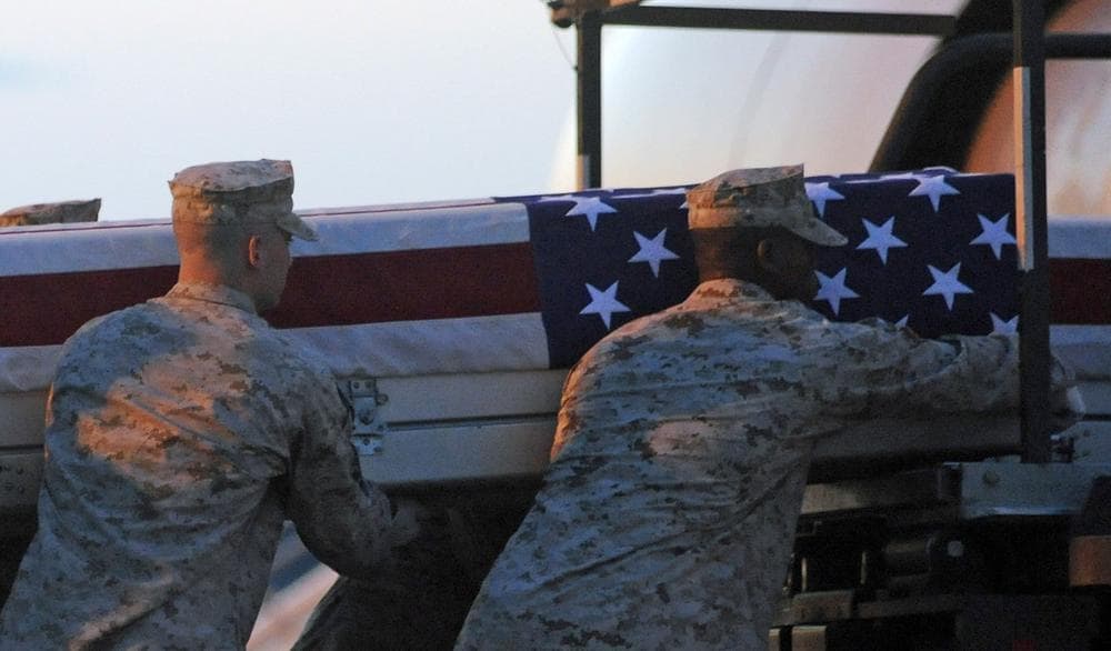 A Marine carry team lifts a transfer case containing the remains of Cpl. Paul J. Miller at Dover Air Force Base, Del., July 21, 2010. (Steve Ruark/AP)