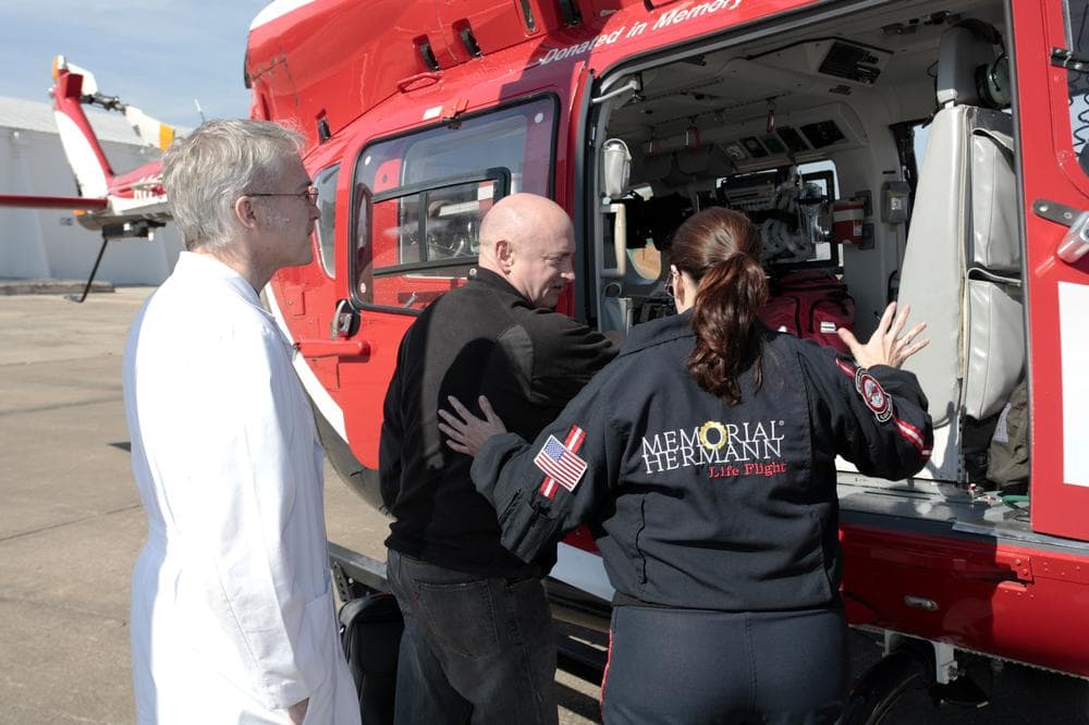 The husband of Rep. Gabrielle Giffords, D-Ariz, Mark Kelly, center, prepares to climb into a helicopter in Houston. Giffords, who is recovering from a gunshot wound to the head was transferred to a Houston intensive care unit. (AP/Office of Rep. Giffords, F. Carter Smith) 