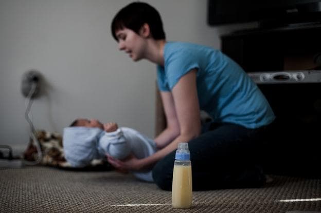 Lindsey Ward dresses her 4-month-old son, Joshua, in her home in Woodbridge, Va., before making a &quot;milk run&quot; to receive donated breast milk from another mother. (Jonathan Makiri/NPR)