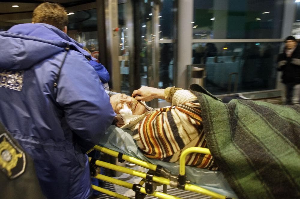 A man wounded in a blast is carried away at Domodedovo airport in Moscow. (AP)