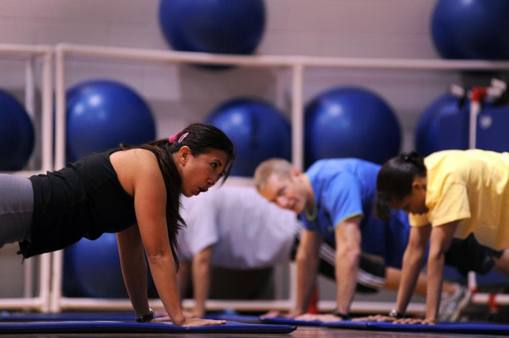 Boot camp fitness instructor Farrah Thompson, leads Airmen and civilians in a fitness class at an Air Force base. (U.S. Air Force photo by Senior Airman Kenny Holston)(Released)