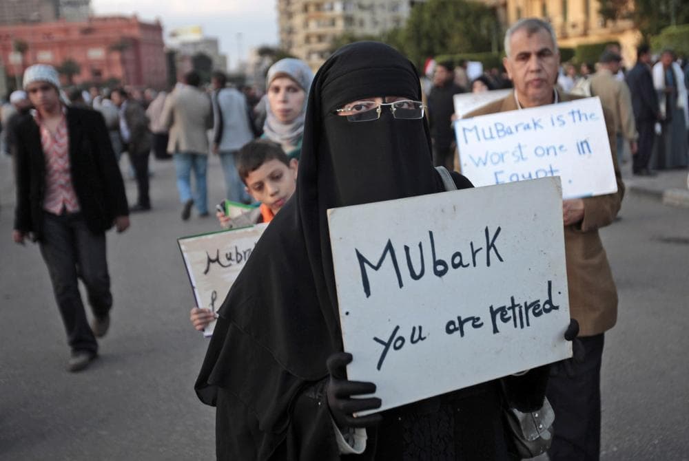 A woman carrying a placard referring to Egyptian President Hosni Mubarak attends a demonstration by anti-government protesters in Cairo's Tahrir Square. (AP)