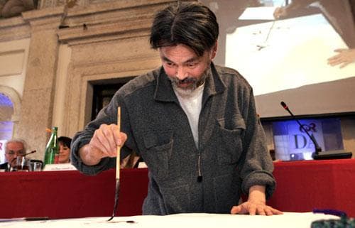 Japanese master calligrapher Norio Nagayama paints a short poem, as part of a conference on Japanese haiku short-poetry. (AP)