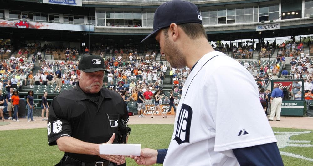 Detroit Tigers pitcher Armando Galarraga, right, hands the lineup card umpire Jim Joyce before the Tigers-Indians game on June 3rd, 2010. (AP Photo/Paul Sancya, File)