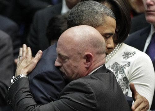 President Barack Obama embraces Mark Kelly, right, the husband of critically wounded Rep. Gabrielle Giffords, at the University of Arizona, Jan. 12, 2011. (AP)