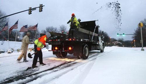 City contractors spread sand on roadways in the early morning hours after an overnight winter storm, Jan. 10, 2011, in Johns Creek, Ga. (AP)