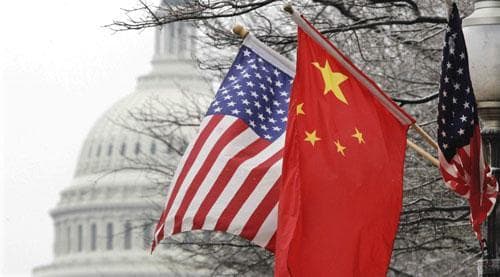 The Capitol dome is seen at rear as Chinese and U.S. flags are displayed in Washington, Jan. 18, 2011. (AP)