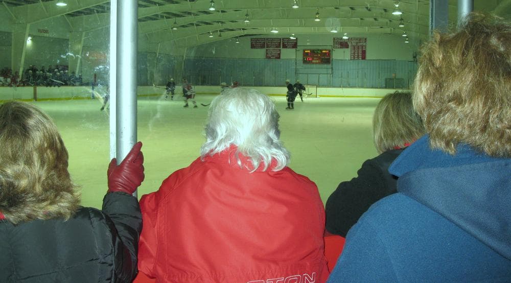 Parents watch the Hingham High School hockey team skate against Marshfield. (Fred Thys/WBUR)