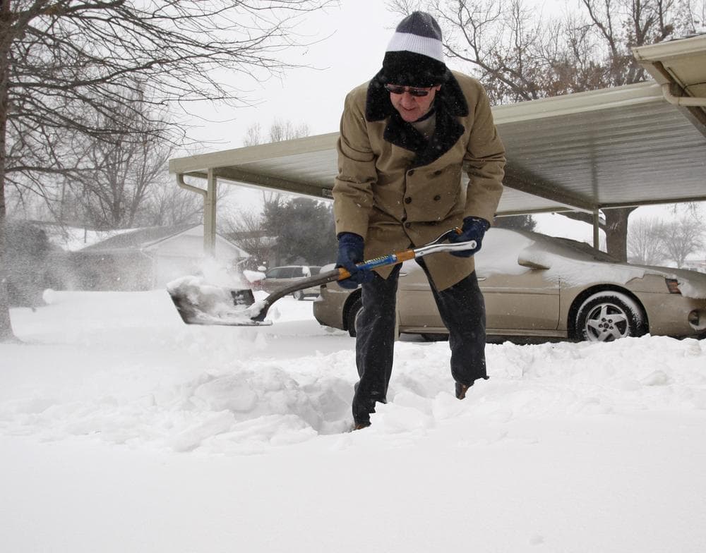 Seventy-six year old Lee Cocklin clears a path in the snow at his home in Oklahoma City. (AP)