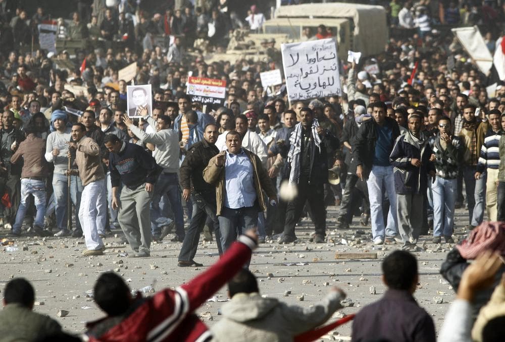 Pro-government supporters, top, clash anti-government protestors in Cairo's main square, Egypt. (AP)