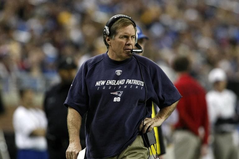 New England Patriots head coach Bill Belichick speaks into his headset as he walks the sideline in the first quarter of an NFL football game with the Detroit Lions, Thursday, Nov. 25, 2010, in Detroit, Mich. (AP Photo/Tony Ding)