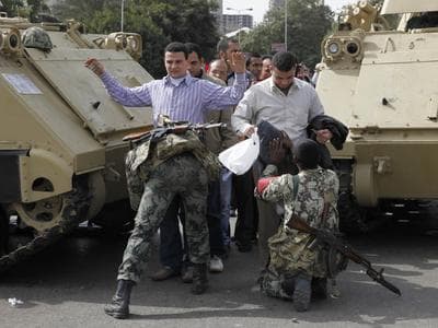 Soldiers searched anti-government protesters heading to Friday rallies in Tahrir Square in downtown Cairo. (AP)